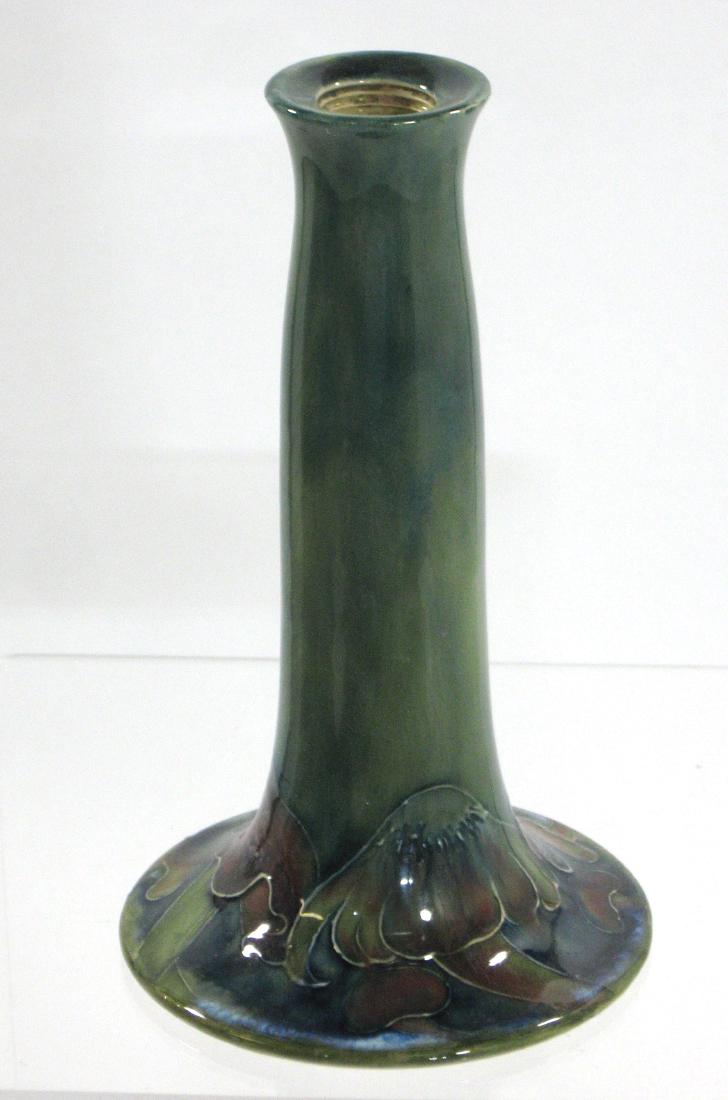 Moorcroft Claremont candlestick: Footed cylindrical stick in green decorated with the mushroom scene, marked with the Rd. number and William Moorcroft signature, 7 1/2" ht. Condition: good but with even crazing