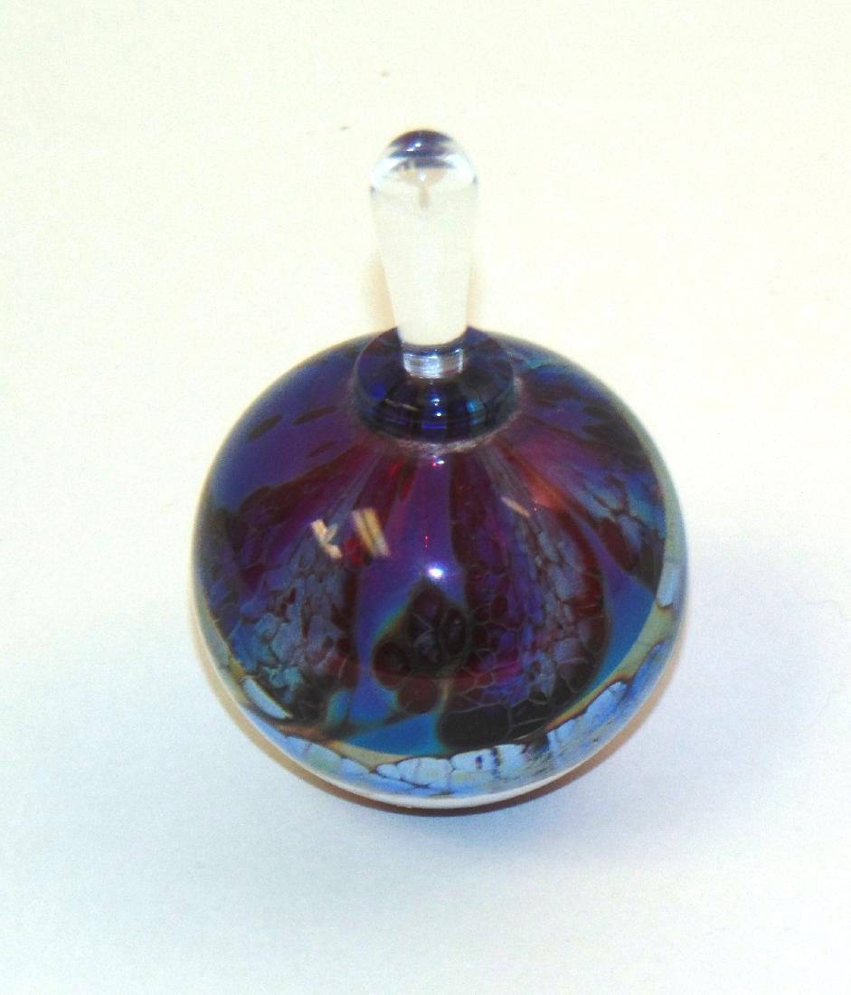 Robert Burch art glass perfume: Round form in translucent red glass decorated with wisps of blue and opalescent clouds, signed Burch 05, 3 1/2' ht. Condition: good with no defects found
