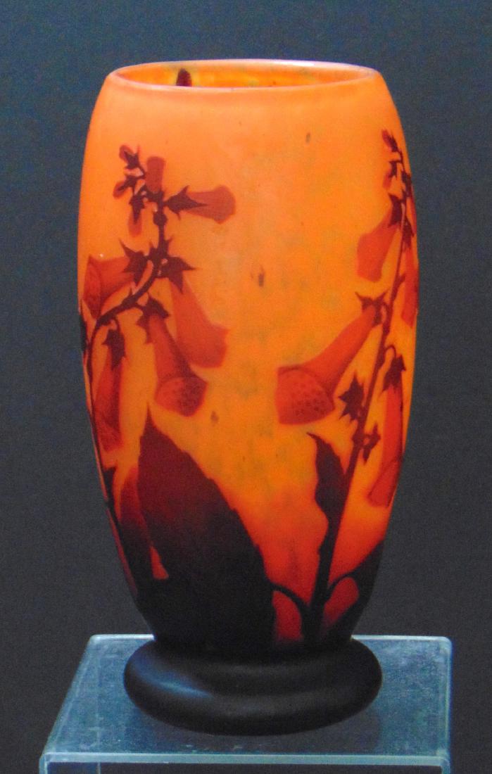 Daum Nancy French cameo vase: Footed cylindrical form in mottled red decorated with Crimson tobacco flowers, signed Daum Nancy, 8" ht. Condition: good with no defects found.
