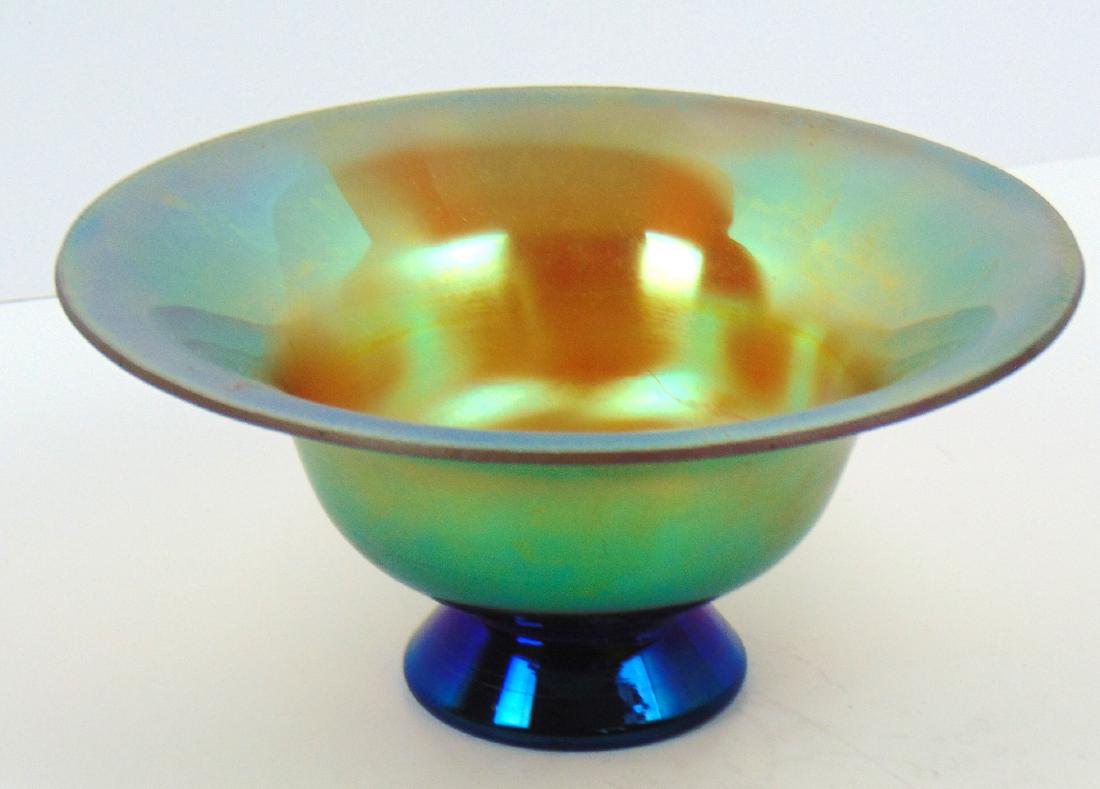 WMF iridescent glass bowl: Footed iridescent gold bowl with rich blue overtones, 8 1/2" wide. Condition: good with no defects found.