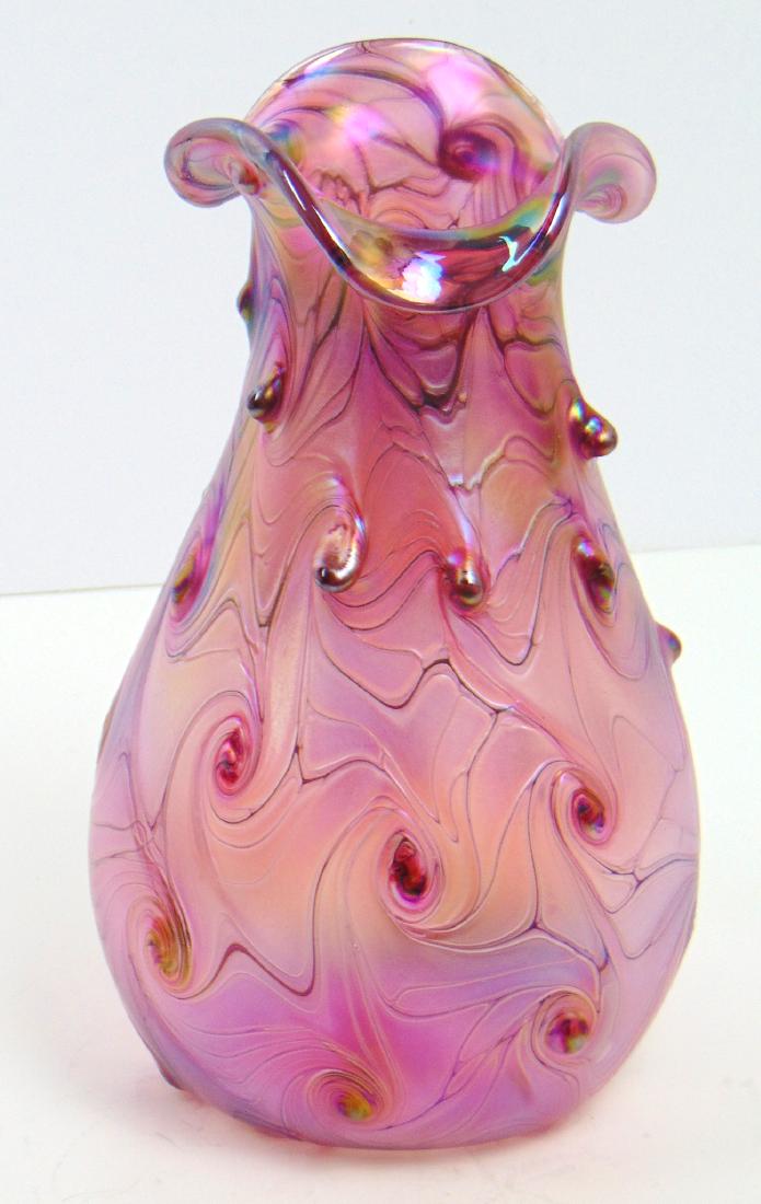 Contemporary Czech art glass vase,: Bulbous form in iridescent cranberry decorated with an undulating hooked feather ending in hobnails, 9" ht. Condition: good with no defects found.
