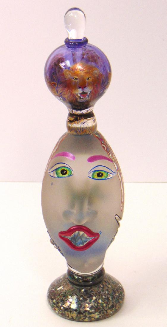 Kurt and Lynda Carlson figural head,: Perfume bottle in a figural head with a balled top with enameled lion, signed and dated 2004, 10 1/2" ht. Condition: good with no defects found