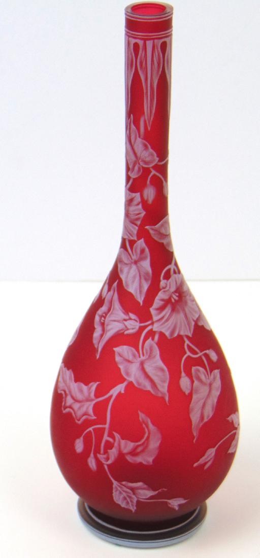 Webb Cameo Morning Glory Glass Vase: Bulbous stick vase in red satin glass decorated with a cascading morning glory extending from an arrow point rim, marked Thomas Webb and Sons, 11" ht. Condition: good with no defects found