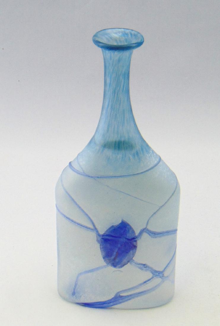 Kosta Boda Bertil Vallien glass vase: Flat bottle form in mottled blue and white decorated with a random blue heart and vine, artist signed B Vallien, 8" ht. Condition: good with no defects found.