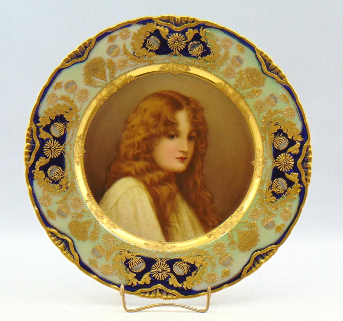 Signed Wagner Royal Vienna plate,: Pictorial medallion of a young lady framed in turquoise and cobalt with overall gold flower scrolling, artist signed Wagner, 9 3/4" wide. Condition: good with no defects found.