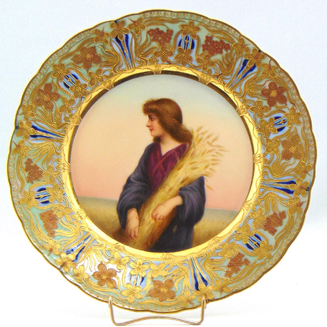 Royal Vienna porcelain plate: Central portrait medallion of Ruth in the wheat field framed with a light blue band of Art Nouveau gold scrolling flowers, marked with the blue Beehive factory back stamp and titled Ruth, marked with 