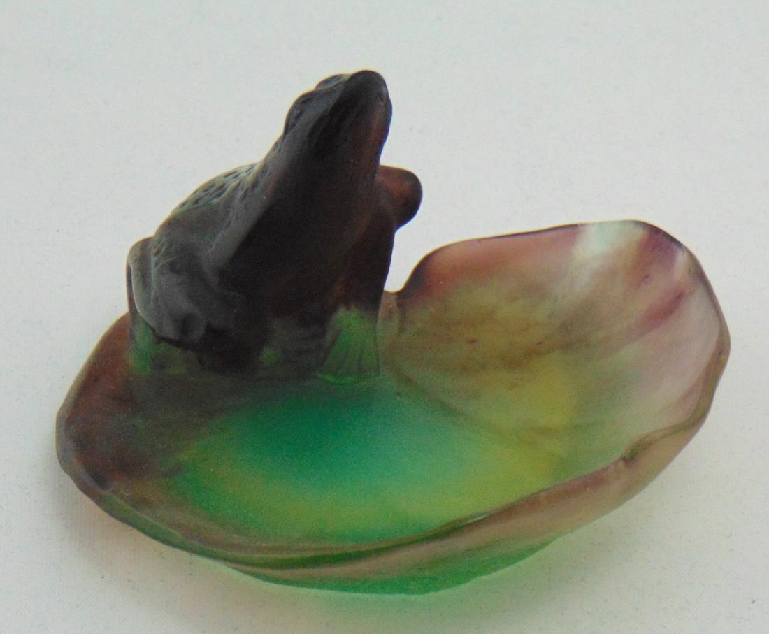 Daum Pate de Verre frog: Figural purple frog set on a purple and green leaf form base, signed Daum Nancy, 3" wide. Condition: good with no defects found.