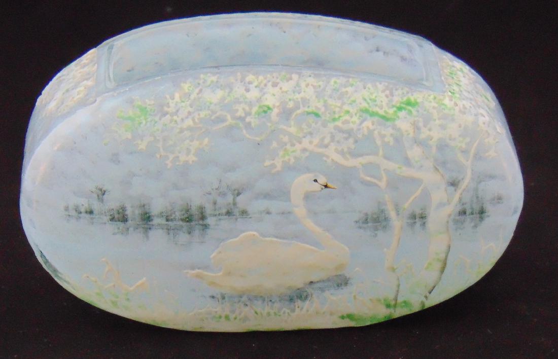 Rare Daum Nancy swan glass vase,: Elongated pillow form in mottled blue decorated front and back with a swimming swan under a green and white tree, signed in gold Daum Nancy, 7" long by 4" tall. Condition: good with no defects found.
