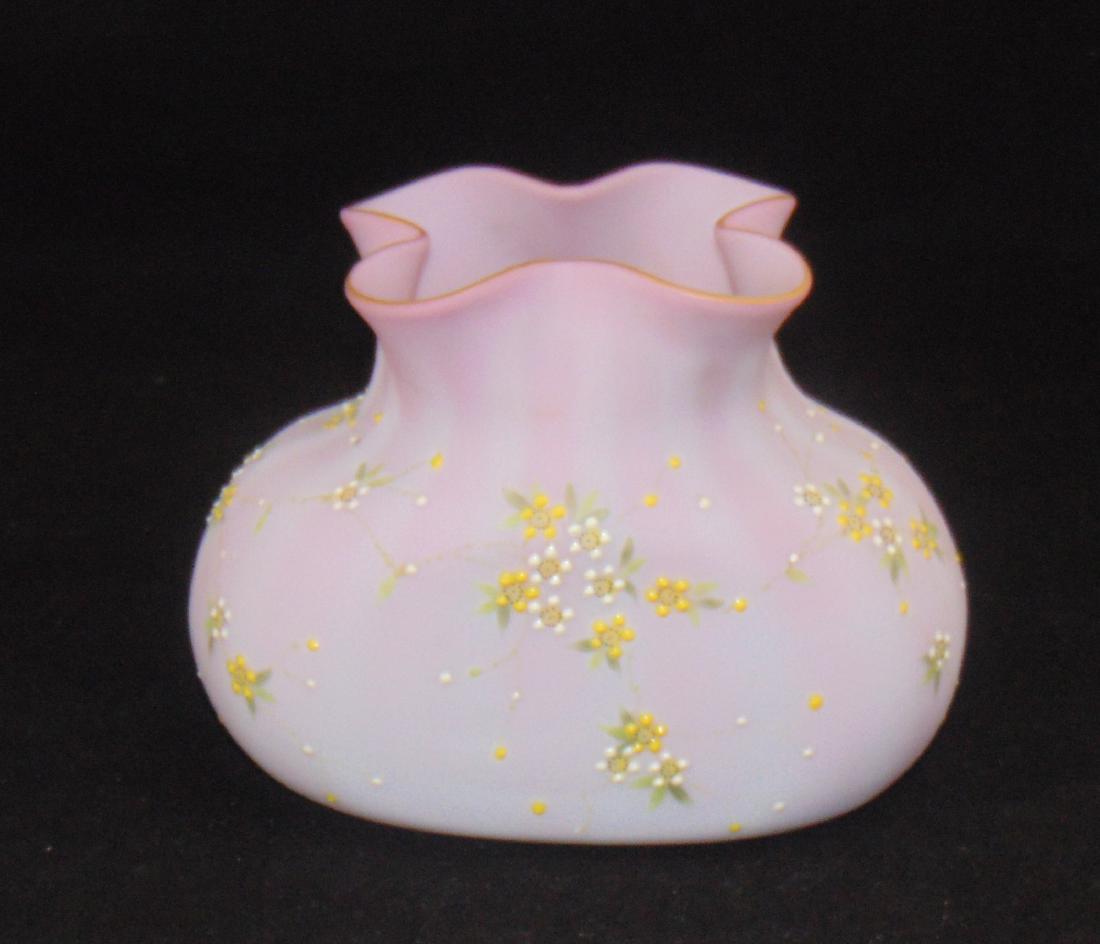 Mt. Washington Peachblow Glass Vase: Ovoid form with a quad-ra-fold rim decorated with yellow and white daisy clusters, 7" long by 5" ht. Condition: crack across the bottom that extends 1" up both sides.