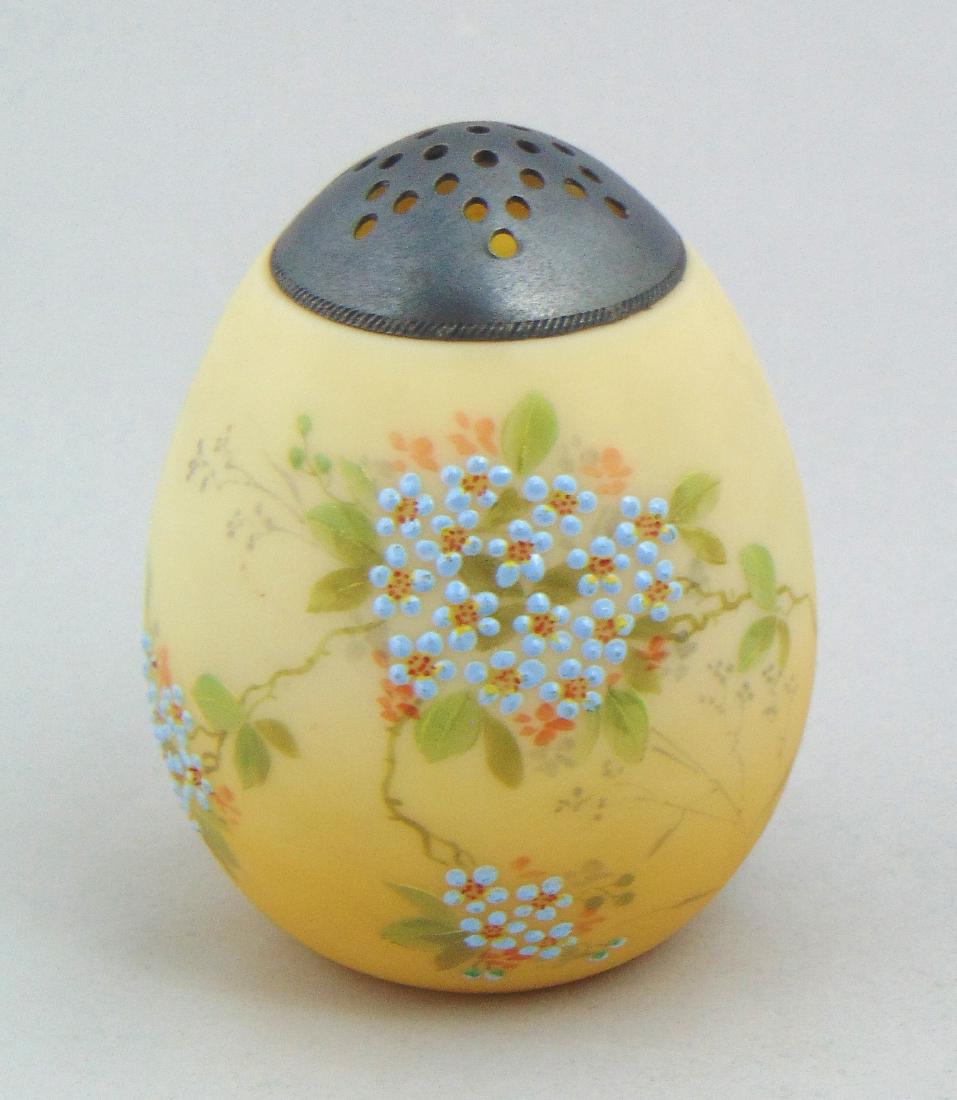 Crown Milano Egg Sugar: Ovoid egg form sugar shaker decorated with five clusters of raise blue daisies, 4 1/2" ht. Condition: good with no defects found.