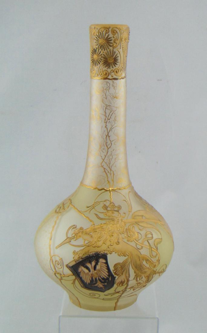 Mt. Washington Royal Flemish vase: Bulbous stick form in raised earth tone panels decorated with a rampant Lion with crown, sword, and shield. Reverse with stippled medallion, adorned with a gold scrolling and flower dollop rim, marked