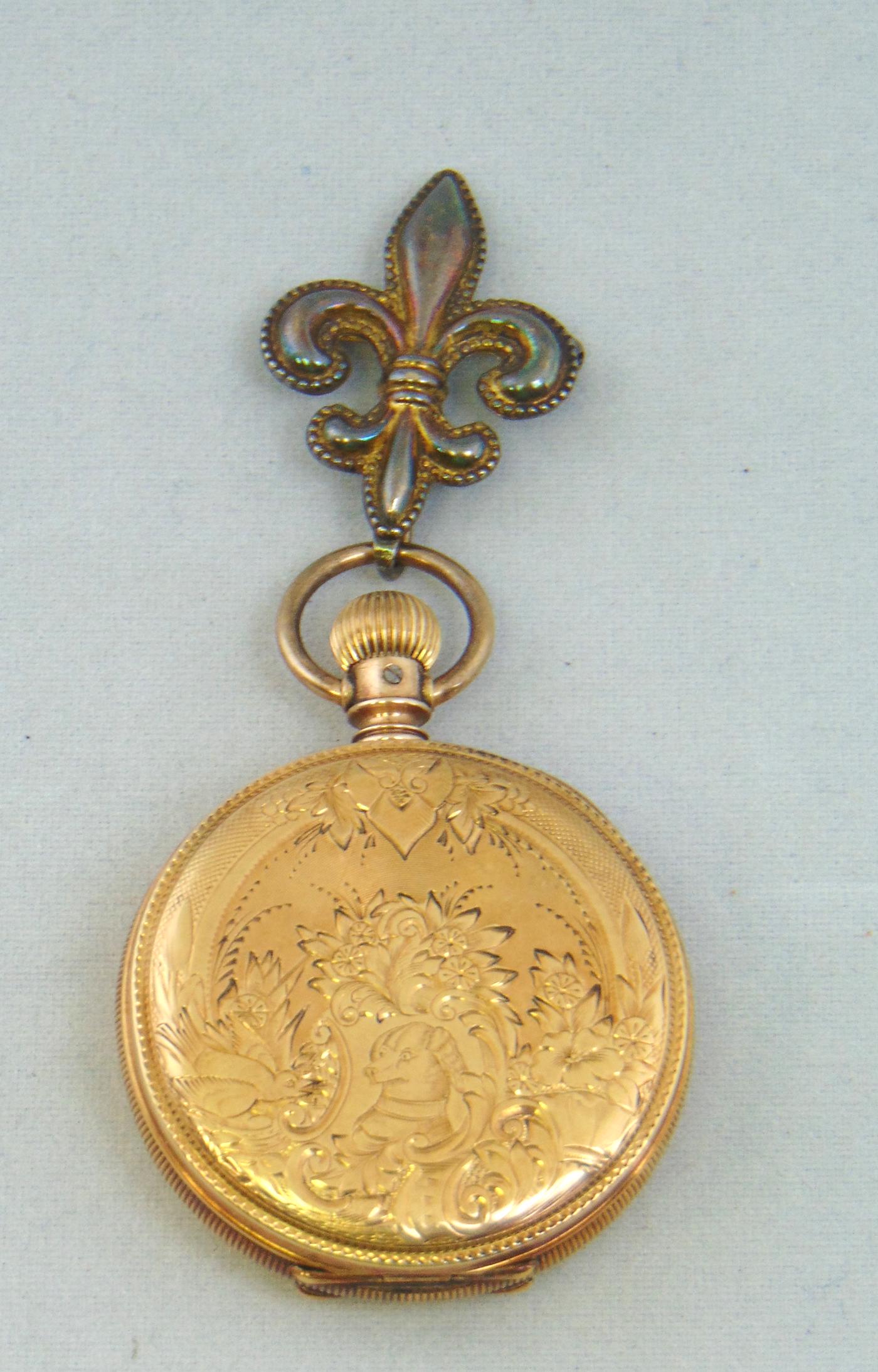 Gold Elgin ladies pocket watch: 12K watch with engraved front with flowers and a dog with engraved reverse, face marked Elgin case with European markings, test 12K, Condition: missing crystal.