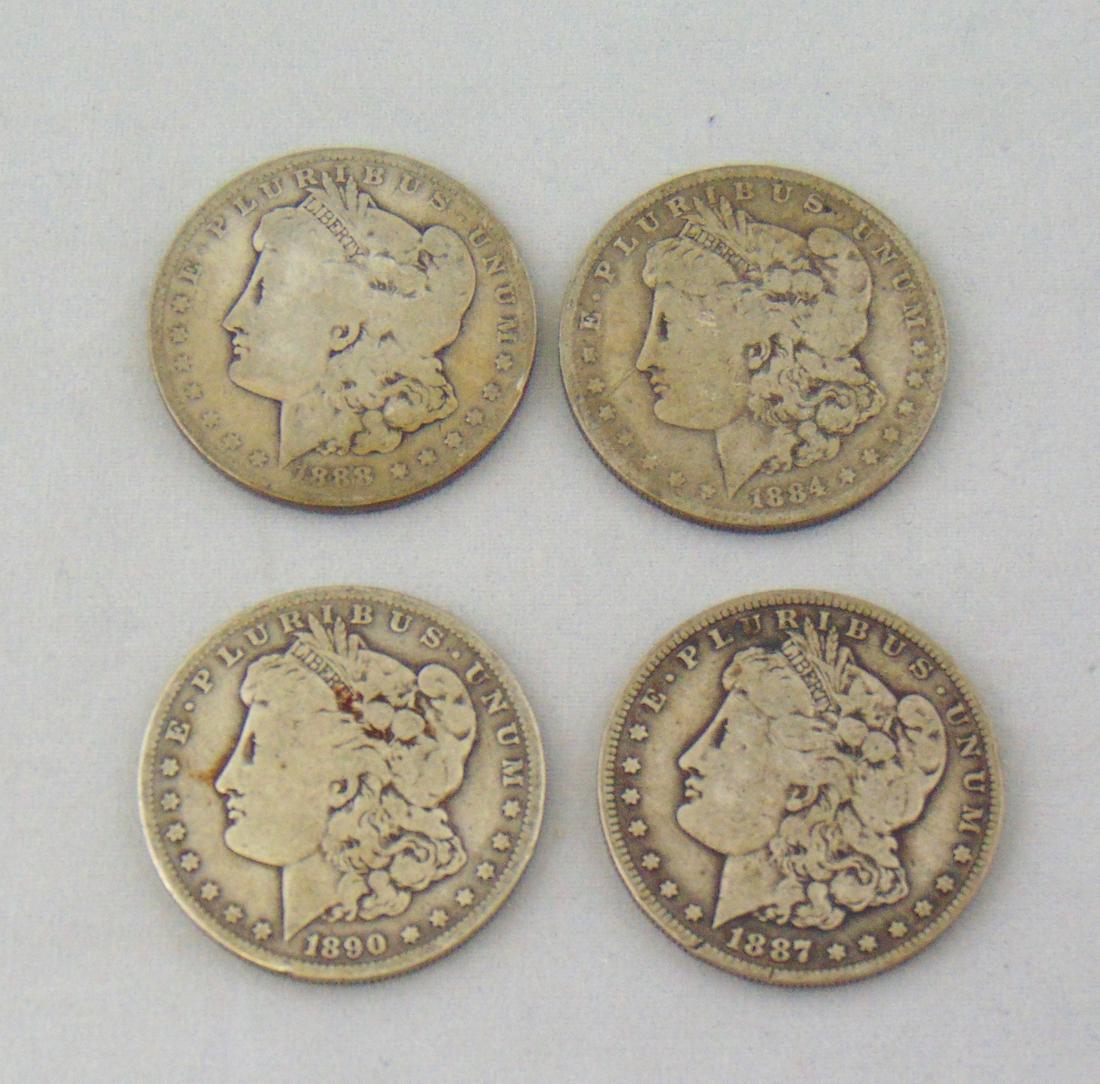 Four Morgan silver dollars: Including a 1884, 1887 O, 1888 O, and a 1890 O. Condition: good