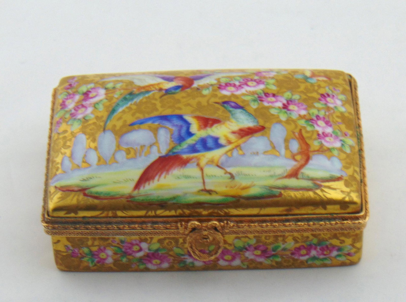 Le Tallec porcelain box: Rectangular form in overall gold decorated with a pictorial of two exotic birds, marked in French hand painted by Le Tallec and has a Christies Auction house paper label, 5 1/2" wide. Condition: good 