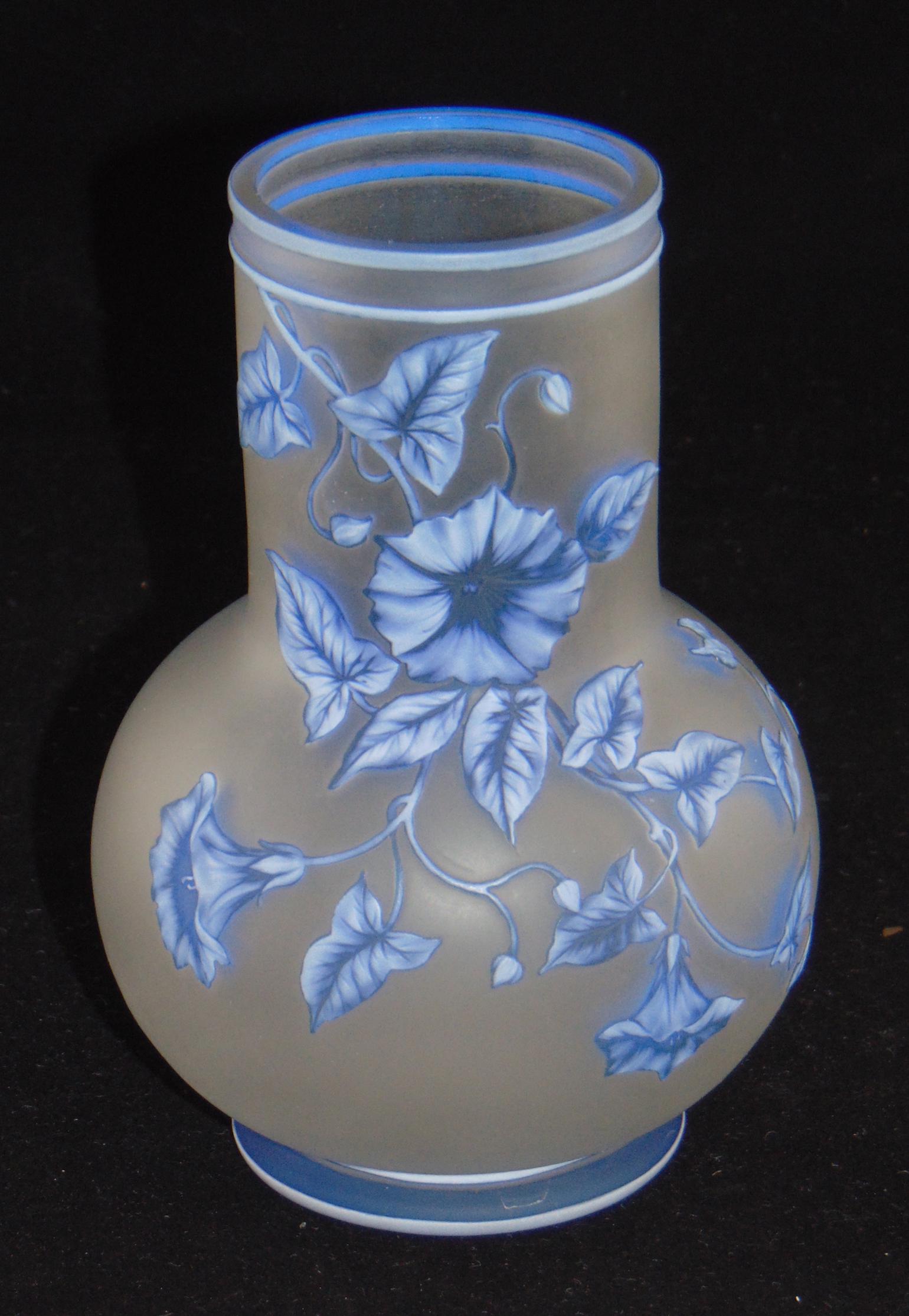 Webb three color cameo glass vase: Bulbous form with a smoke stack neck in frosted glass decorated with a cascading white over blue morning glory and butterfly on the reverse, signed with an acid stamp Thomas Webb and Sons, 6" ht. Cond