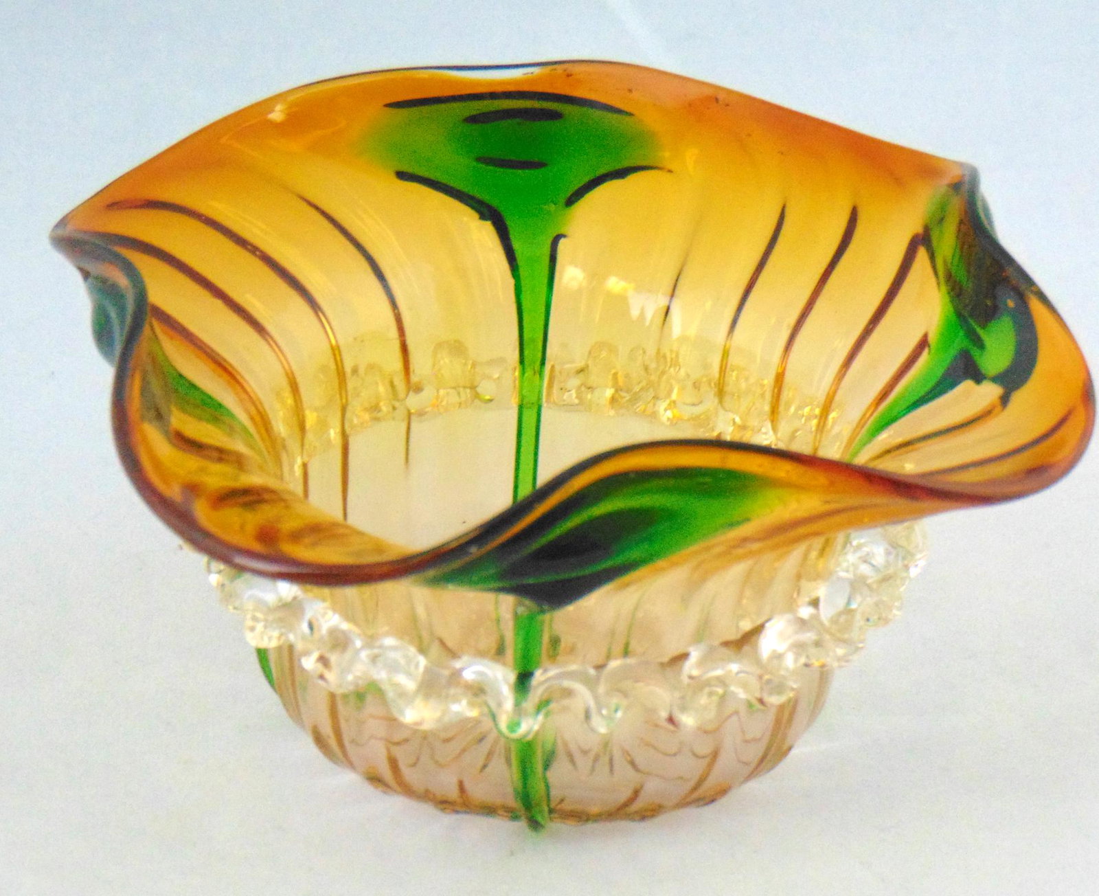 Stuart crystal art glass bowl: Amber sweet meat bowl with a rigaree waist adorned with green side tad poles, 5 1/2" wide. Condition: good with no defects found.