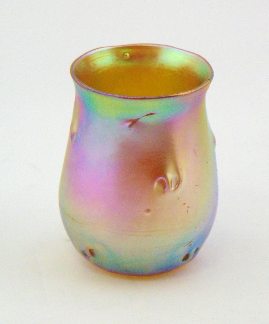 Tiffany gold Favrile tumbler: Barrel form in iridescent gold decorated with pig tail prunts, L. C. T. O7277, 3" ht. Condition: good with no defects found