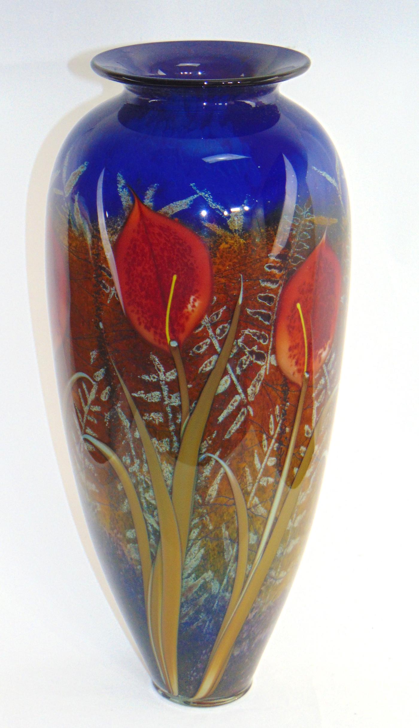 Rick Satava Lily in the Meadow vase: Tall cylindrical shouldered form with six red stemmed Lilies on a green and brown grass field, titled "Red Lily Blue Meadow" signed Satava 497-08, 17' ht. Condition: good with no defects found