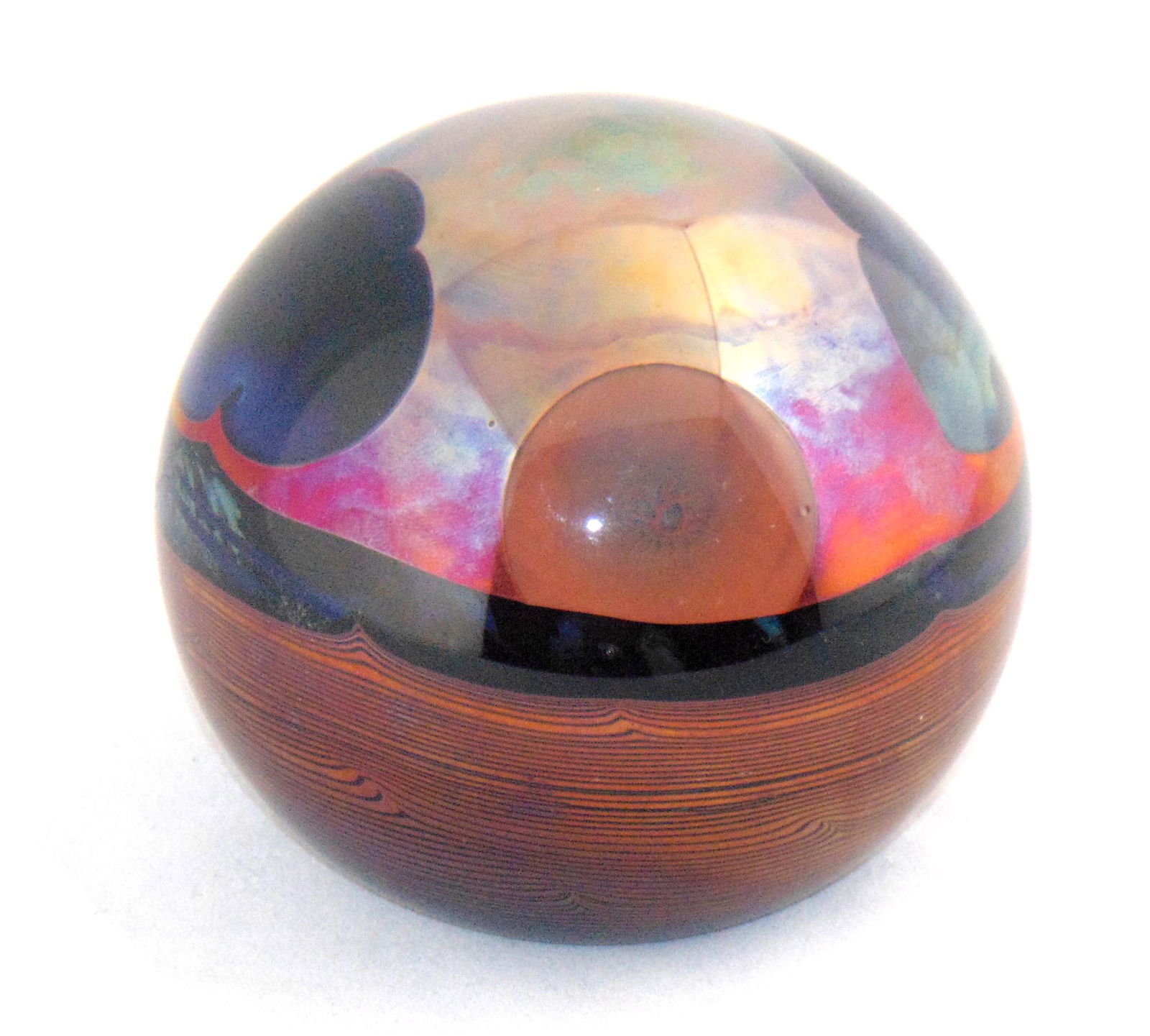 John Lewis orb paperweight: Orb form in a planet design with a crimson moonscape with blue clouds, signed Lewis Studios 76, 4" wide. Condition: good with no defects found.