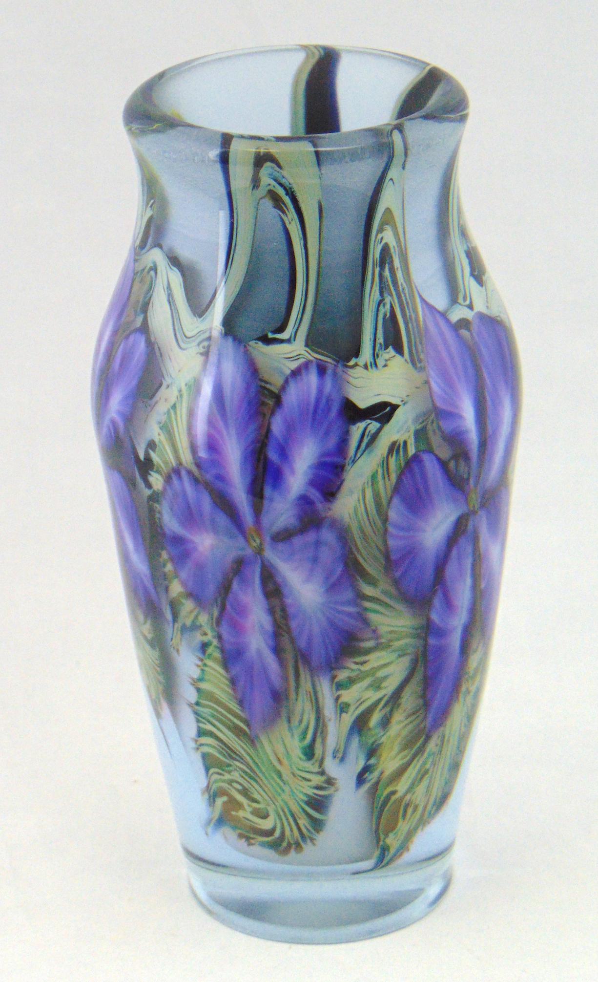 Daniel Lotton art glass vase: Cylindrical form in powder blue decorated with large purple flowers, signed D Lotton 99, 8 1/4" ht. Condition: chip to the foot rim