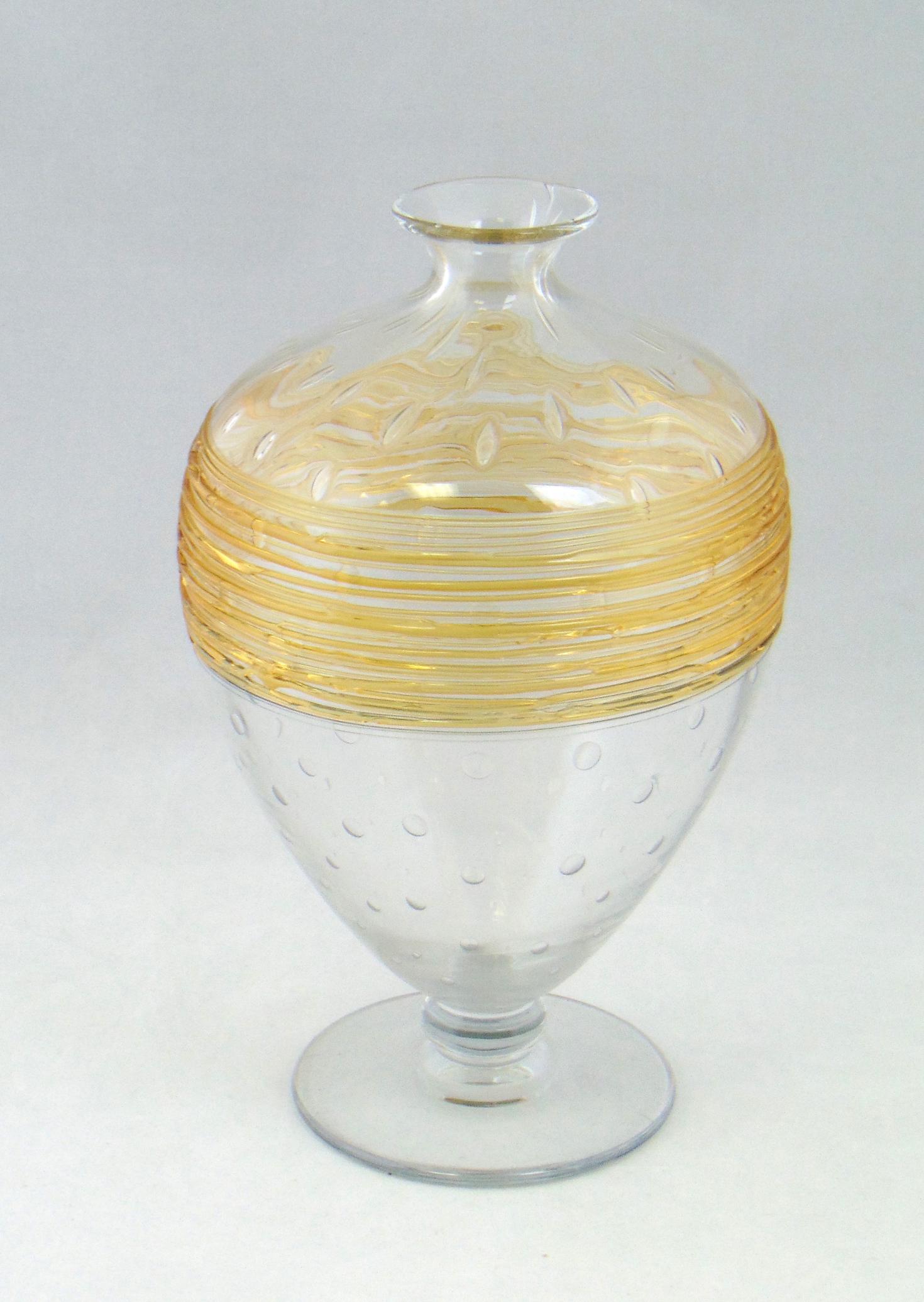 Large threaded glass vase: Footed fat bottle form in clear glass decorated with amber threading and adorned with control bubbles, 10" ht. Condition: good with no defects found.