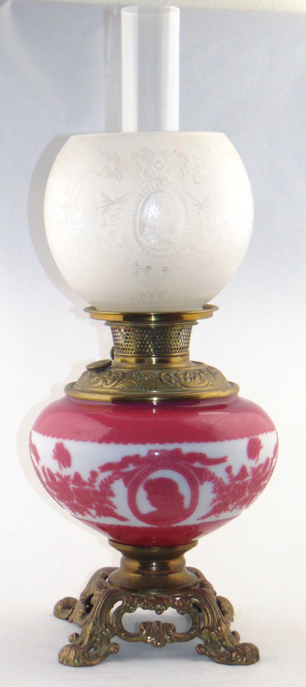 Mt Washington cameo parlor lamp: Gone with the Wind parlor lamp with a ovoid pink cameo base with figural medallions and flower fitted with a etched shade with like design, font marked BH for Bradley and Hubard, 22" to the top of the