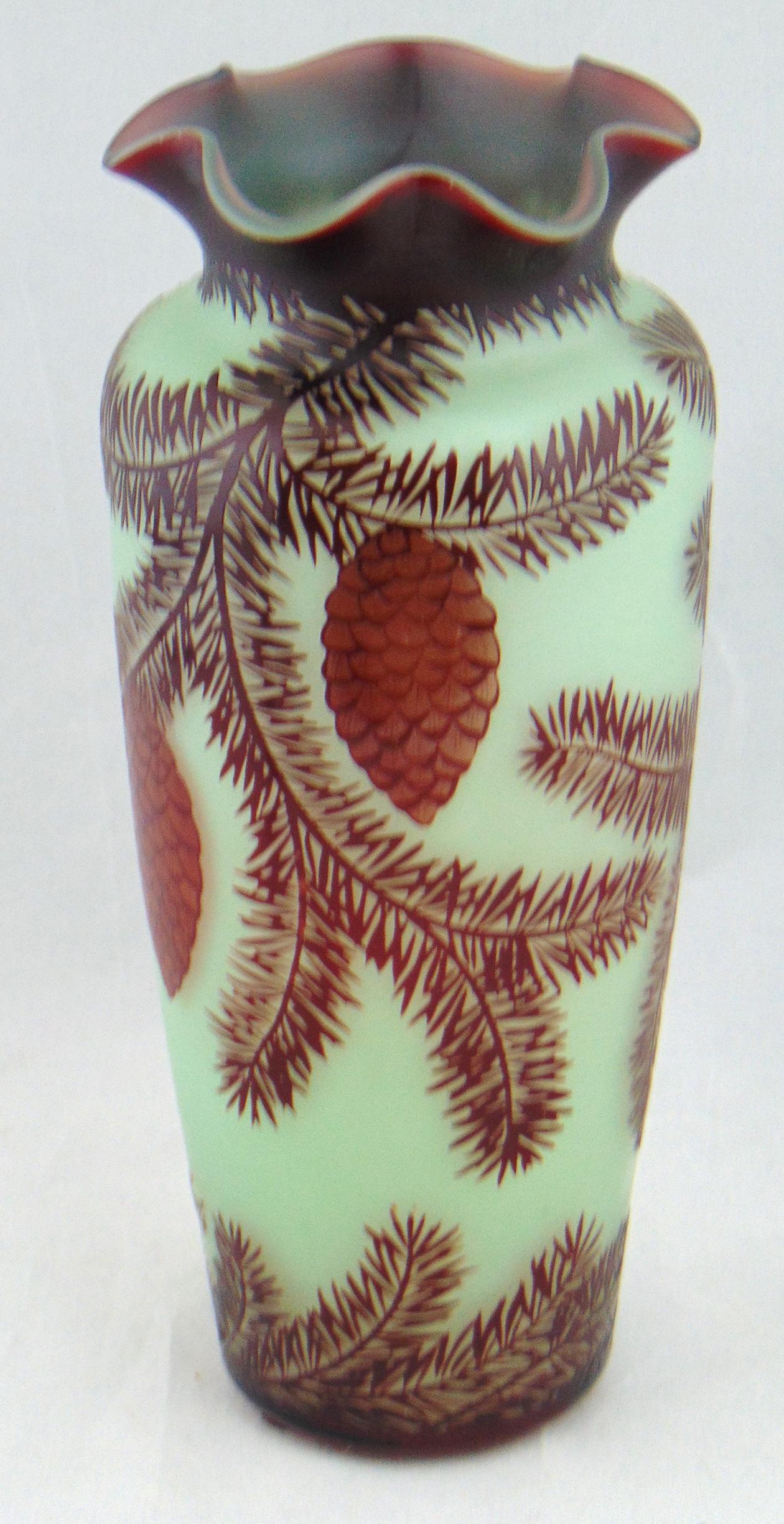 Loetz German cameo glass vase: Cylindrical form in chartreuse glass decorated with a cascading crimson pine cone branch, signed Ca Loetz, 8" ht. Condition: good with no defects found.