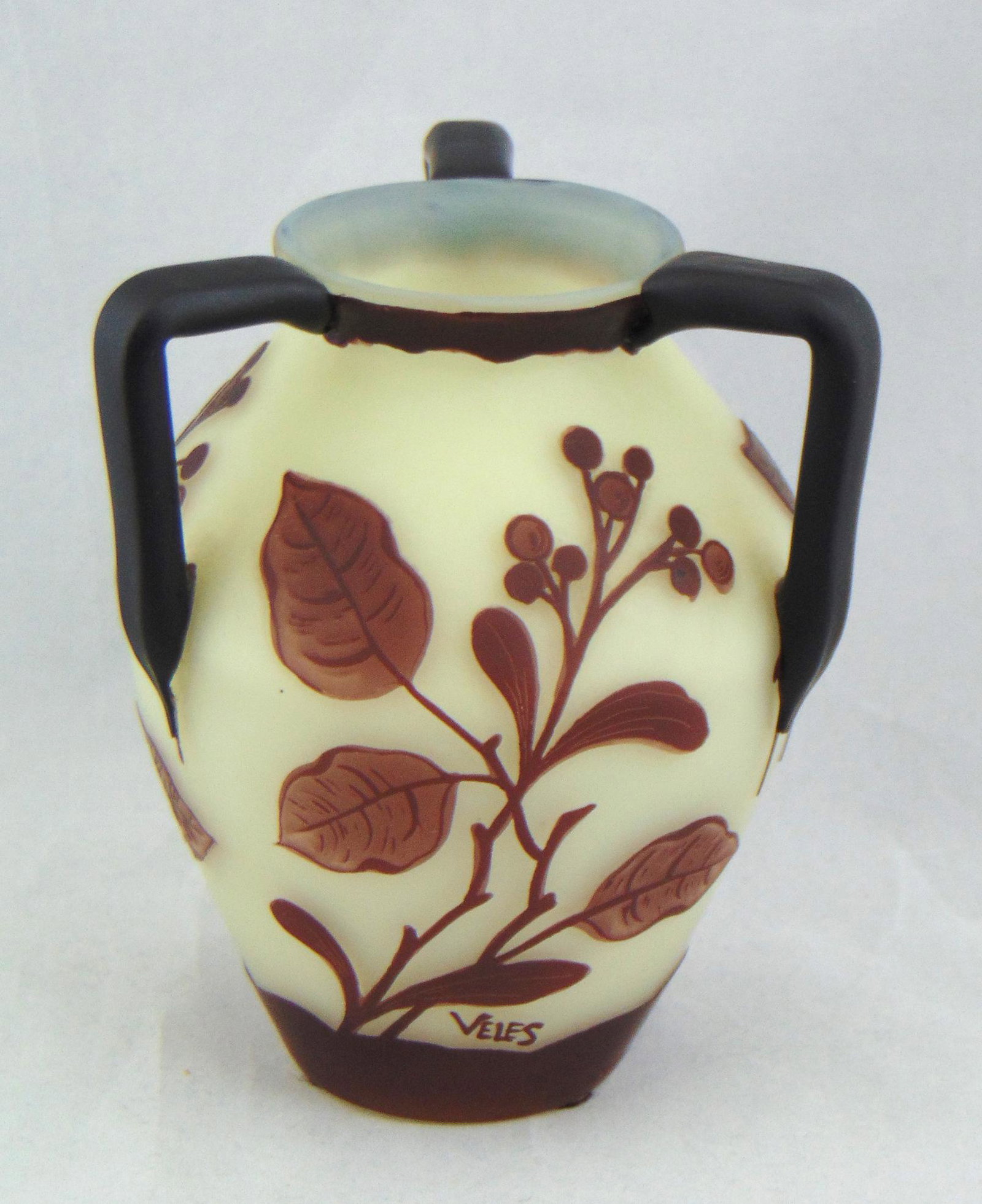 Veles Loetz German Cameo glass vase: Produced by Loetz, ovoid form glass vase with three side handles in opal glass decorated three stemmed branches, signed Veles, 5 1/2" ht. Condition: good with no defects found.