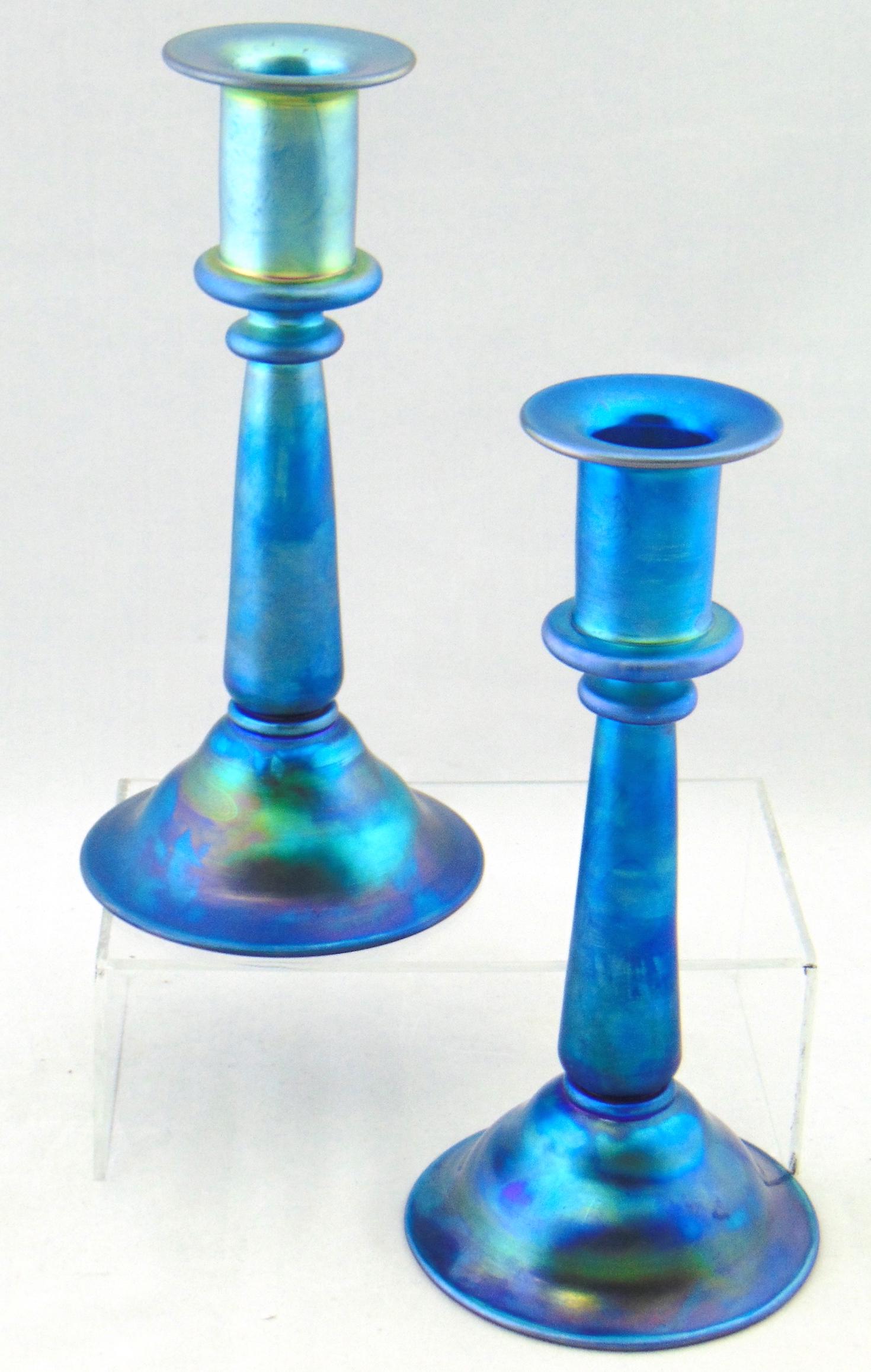 Steuben Blue Aurene glass candlesticks: Column form in Blue Aurene glass shape # 2933, both signed Aurene 2933 and both carry original paper labels, 8 1/2" ht. Provenance: Rockwell Gallery to current owner. Condition: good with no defects f