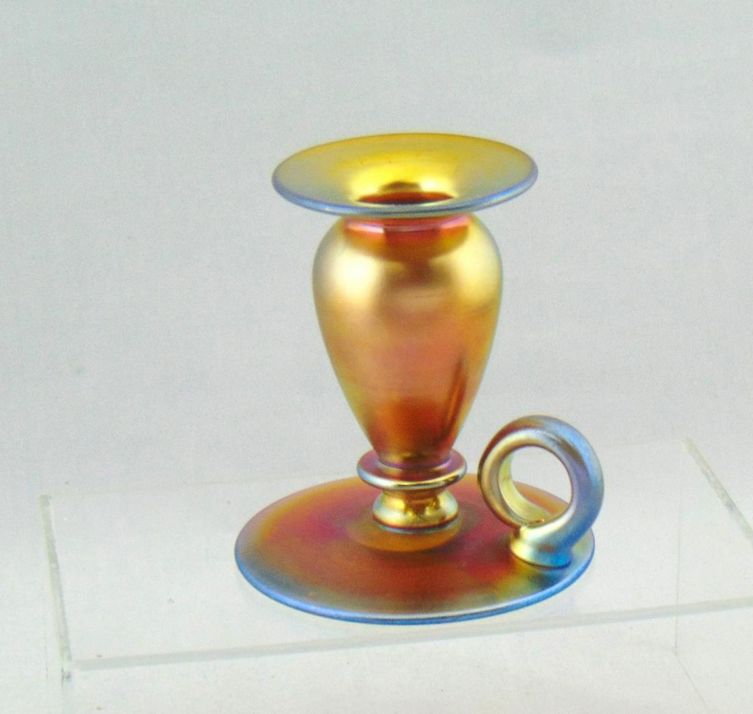 Steuben Gold Aurene glass candlestick: Footed Colonial form with finger holder, signed Aurene 5146, 4" ht. Condition: good with no defects found.