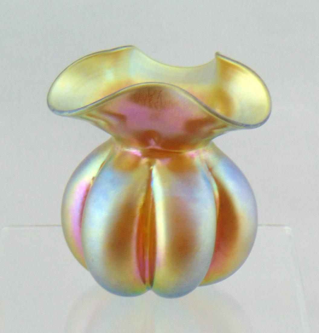 Steuben melon ribbed glass vase: Ovoid melon ribbed form with a tri-fold rim in Gold Aurene signed Aurene 168, 3 1/2" ht. Condition: good with no defects found