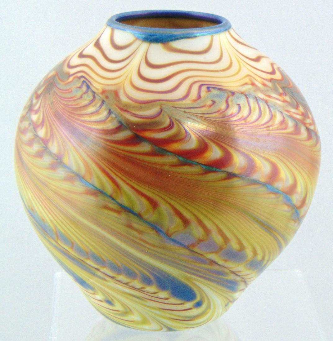 Orient and Flume iridescent glass vase,: Ovoid form in decorated with an undulating red and blue diagonal feather on an amber ground, signed Orient and Flume, 6" ht. Condition: good with no defects found.