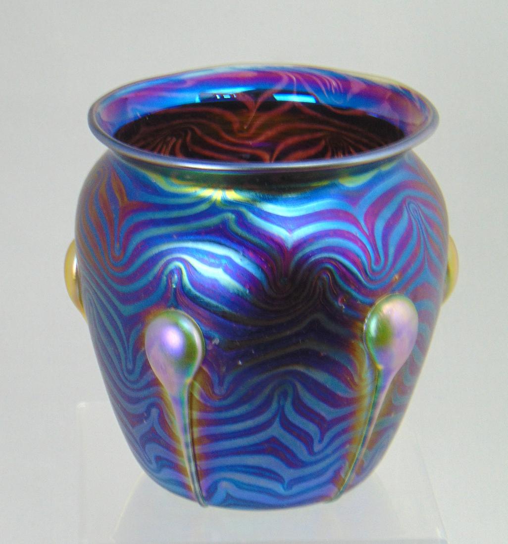 Contemporary Czech art glass vase: Iridescent blue glass vase in a King Tut design decorated with five iridescent gold tad poles, 5 1/2" ht. Condition: good with no defects found.