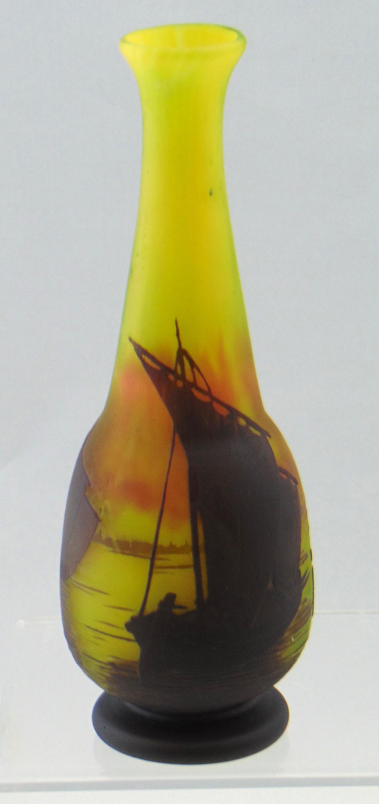 Daum Nancy French cameo glass vase: Footed bulbous stick vase in yellow and crimson glass decorated with four sailing ships, signed in cameo Daum Nancy, 8 1/4" ht. Condition: good with no defects found.