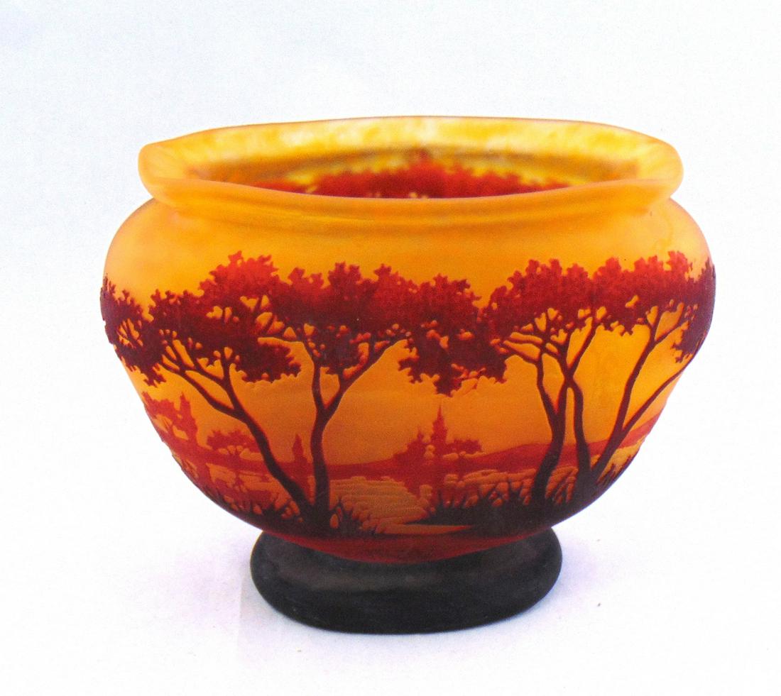 Daum Nancy French cameo glass vase: Footed flat sided form in orange glass decorated with a crimson tree and lake scene, 6" ht by 8" wide. Condition: good with no defects found.