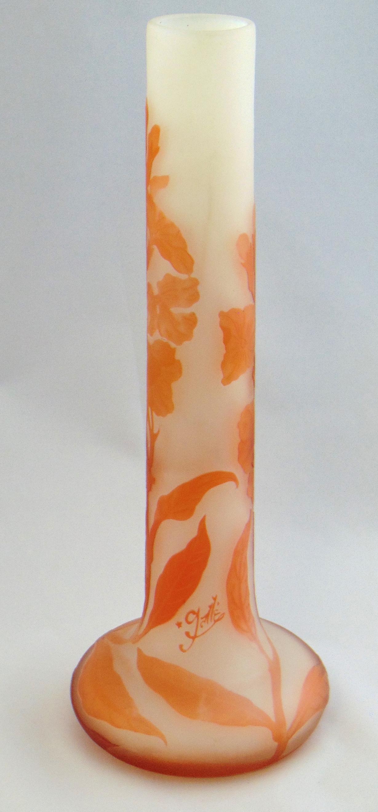 Galle French cameo glass vase: Stick vase in opal glass decorated with a orange flowering branch signed in cameo Galle, 13" ht. Condition: good with no defects found.