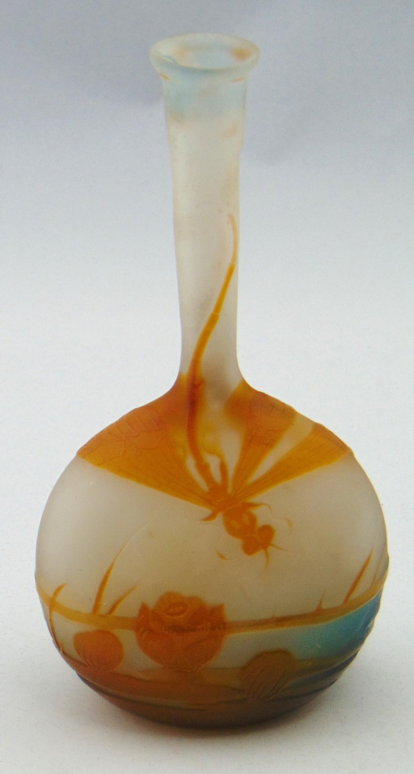 Galle banjo cameo glass vase: Banjo form in frosted to blue glass decorated with an amber pond scene of a flying dragonfly, signed in cameo Galle, 6 1/2" ht. Condition: small chip to the underside of rim