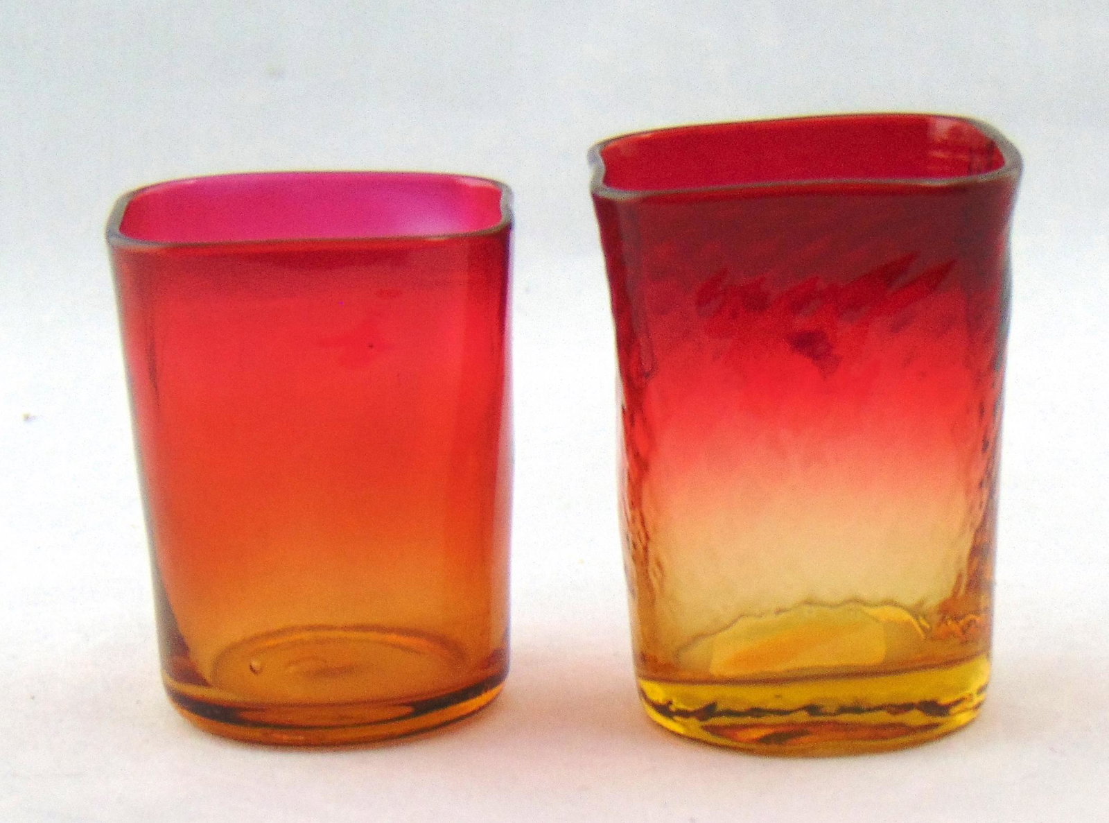 Two Amberina glass toothpicks: Cylindrical form one in the optic diamond pattern each with square mouth rims, 2 1/2" ht. PROVENANCE: Earlys Auction to the Black Collection. Condition: good with no defects found