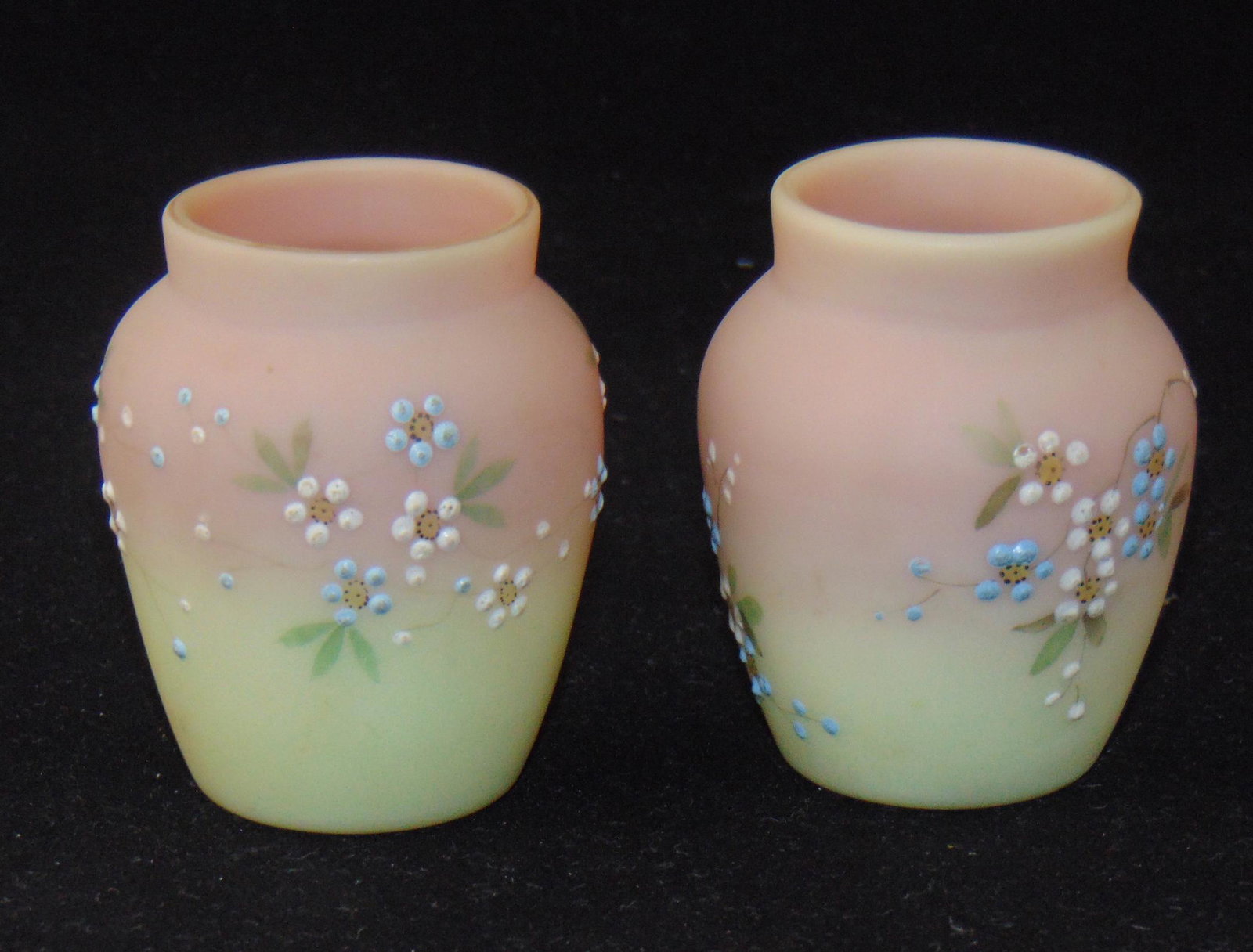 Mt. Washington Burmese toothpicks: Barrel form in amber to pink each decorated with blue daisies, 2 1/2" ht. Condition: good with no defects found.