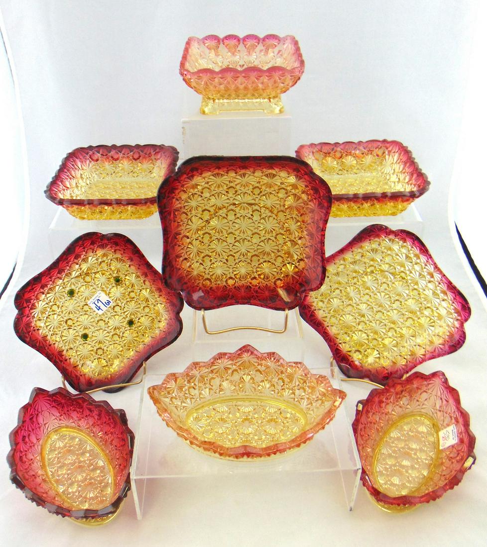 Group of 9 Hobbs Amberina glass items: 9 pressed glass Amberina dishes each in the daisy and button pattern, including three canoes, two square bowls, one footed bowl and three square plates, widest 5 1/2" wide. PROVENANCE: Earlys Auction 