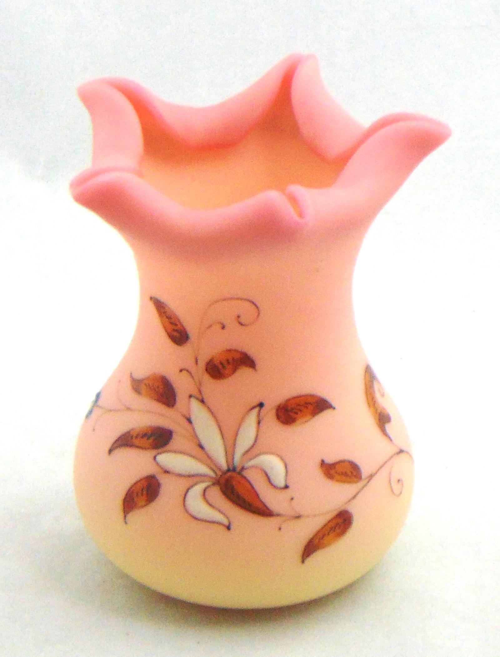 Webb Burmese decorated glass vase: Bulbous form with a five pointed star rim decorated with white and blue flowers on brown stems, 3 1/4" ht. Condition: good with no defects found