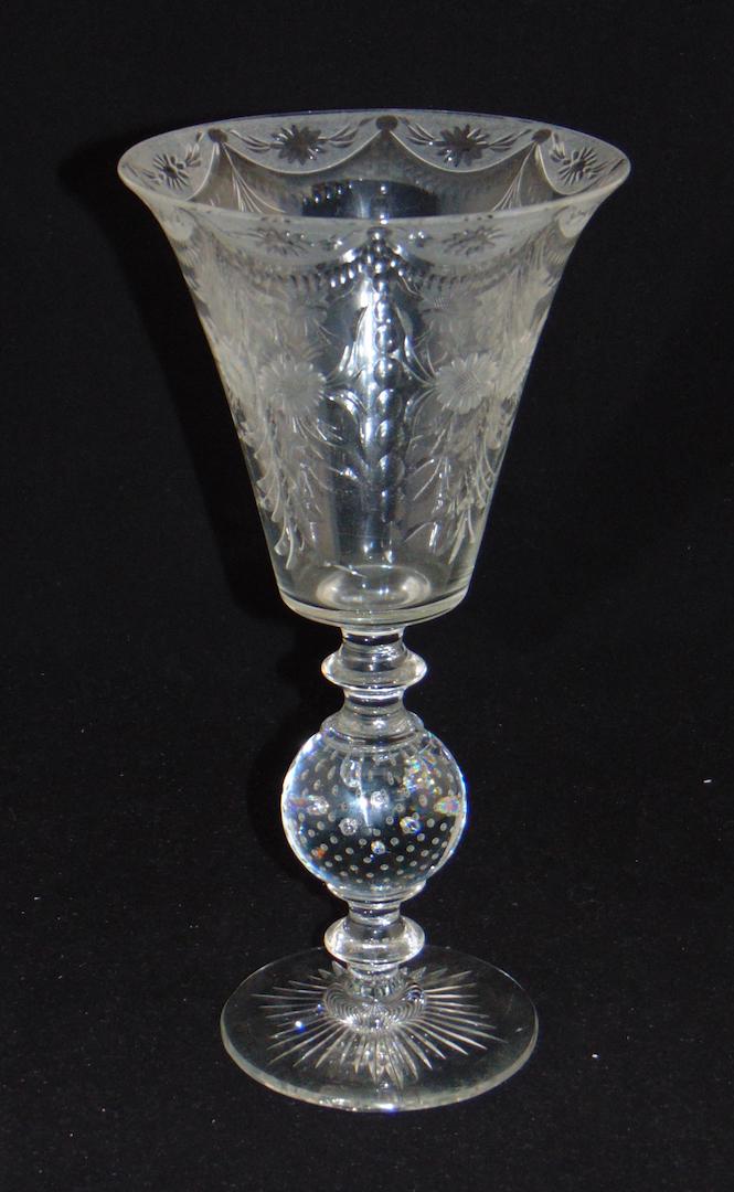 Pairpoint cut glass compote: Tall trumpet form compote with a controlled bubble standard etched with flowers and draped scrolling, 11 1/2" ht. Condition: good with no defects found.