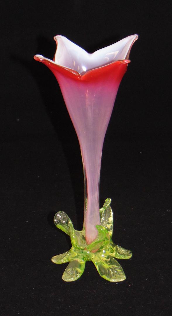 Vaseline and cranberry flower form: Cranberry opalescent flower form set in a Rigaree foot of Vaseline leaves, attributed to Powell, 9 1/2" ht. Condition: good with no defects found.