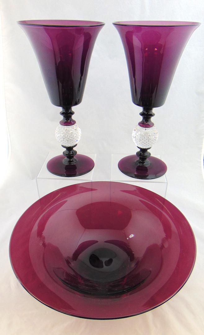 Pairpoint Amethyst glass Console set: Including two large footed purple compote vases with controlled bubble standards, together with a central compote, 12" ht. Condition: good with no defects found.