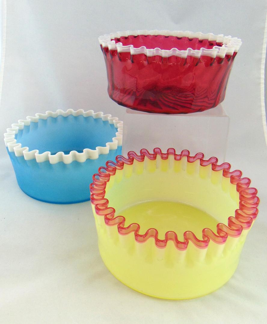 Three Hobbs Brockunier glass bowls: Each Hobbs #205 bowls, ovoid form with a scalloped rim one in lemon to rose, one cranberry to white and the last satin blue to white, 8" wide. Condition: good with no defects found.