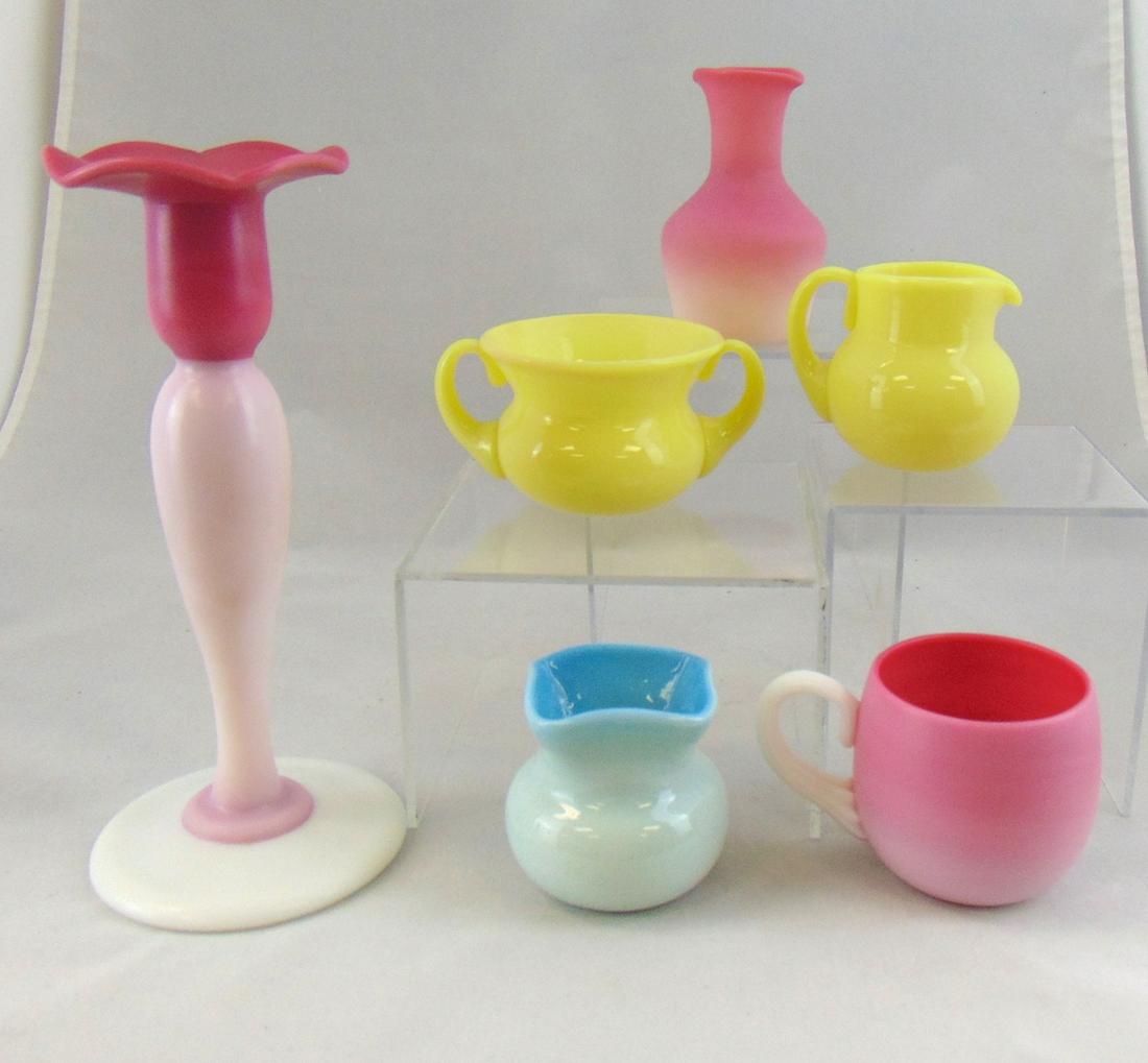 Six Pairpoint glass items: Including a tall Peachblow candlestick, Peachblow cup and vase, yellow creamer and sugar and a blue vase, tallest 8" ht. PROVENANCE: Earlys Auction to the Black Collection. Condition: good with no def