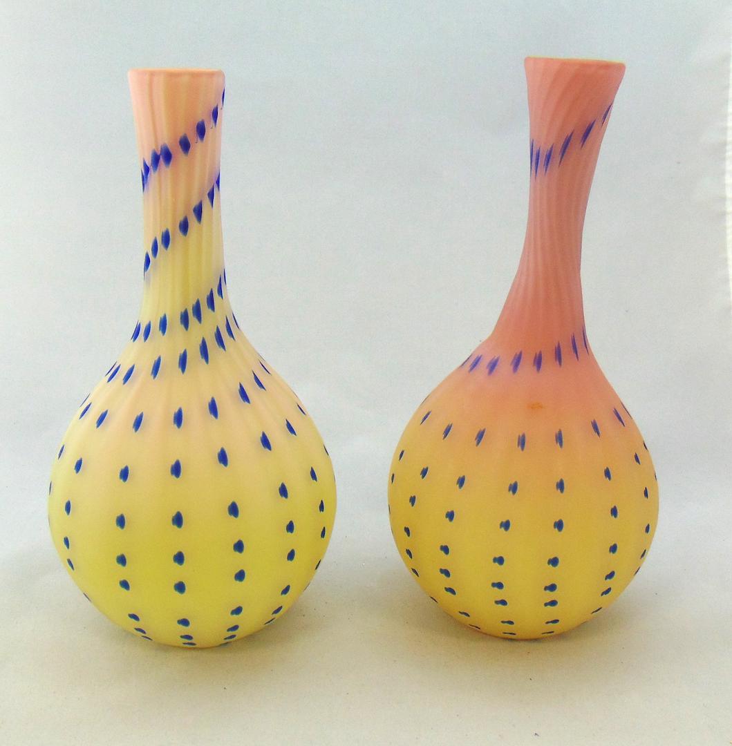 Two Italian Burmese glass vases: Bulbous form in Burmese glass decorated with a blue zipper, one with a label Vetro Artistico Veneziano, 11" ht. Condition: good with no defects found.