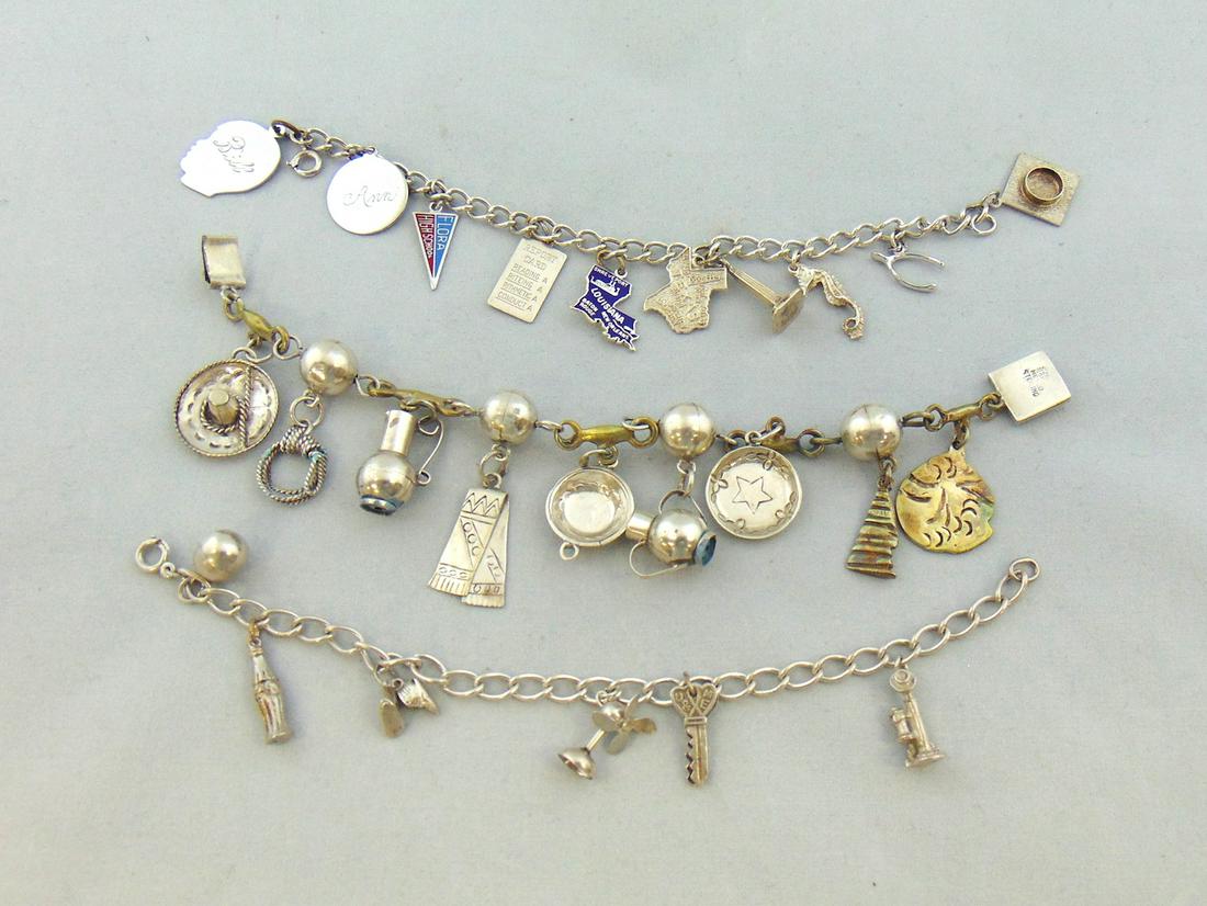 Three Sterling charm bracelets: Three marked Sterling charm bracelets from the 60's. Each bracelet marked Sterling, some charms marked, overall weight 2.75 troy oz. Together with extra charges. NOTE: This is an overall weight we hav
