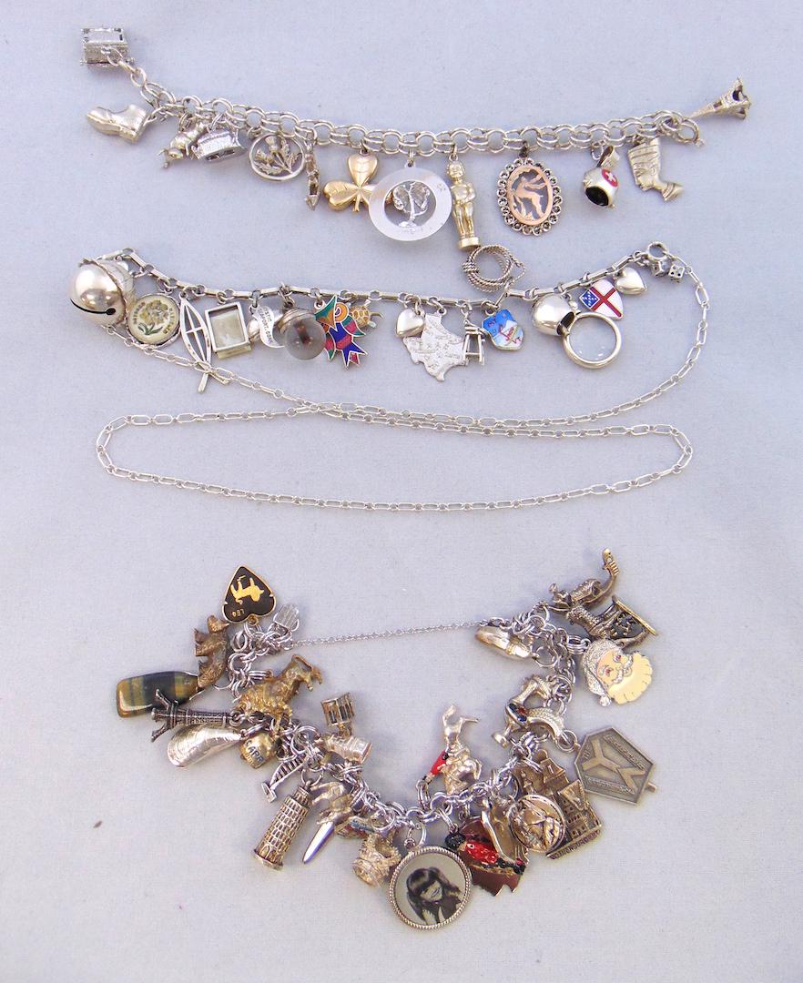 Three Sterling charm bracelets: Three marked Sterling charm bracelets from the 60's. Each bracelet marked Sterling, some charms marked, 5.70 troy oz. NOTE: This is an overall weight we have not checked each charm for its silver cont