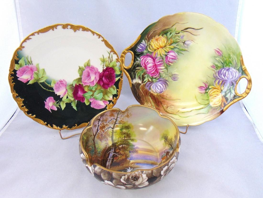 Two Limoges and a Noritake porcelain,: Including a gilt rim plate with roses, a two handle tray with mums and a rose bowl with interior farm scene, all marked, largest 11 1/2" wide. Condition: good with no defects found.